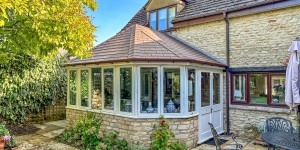 Conservatory fitted with CI Groups' insulation with a fireplace and dining area
